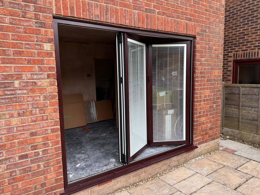 open bifold pic Bifold Brown Doors on red brick house